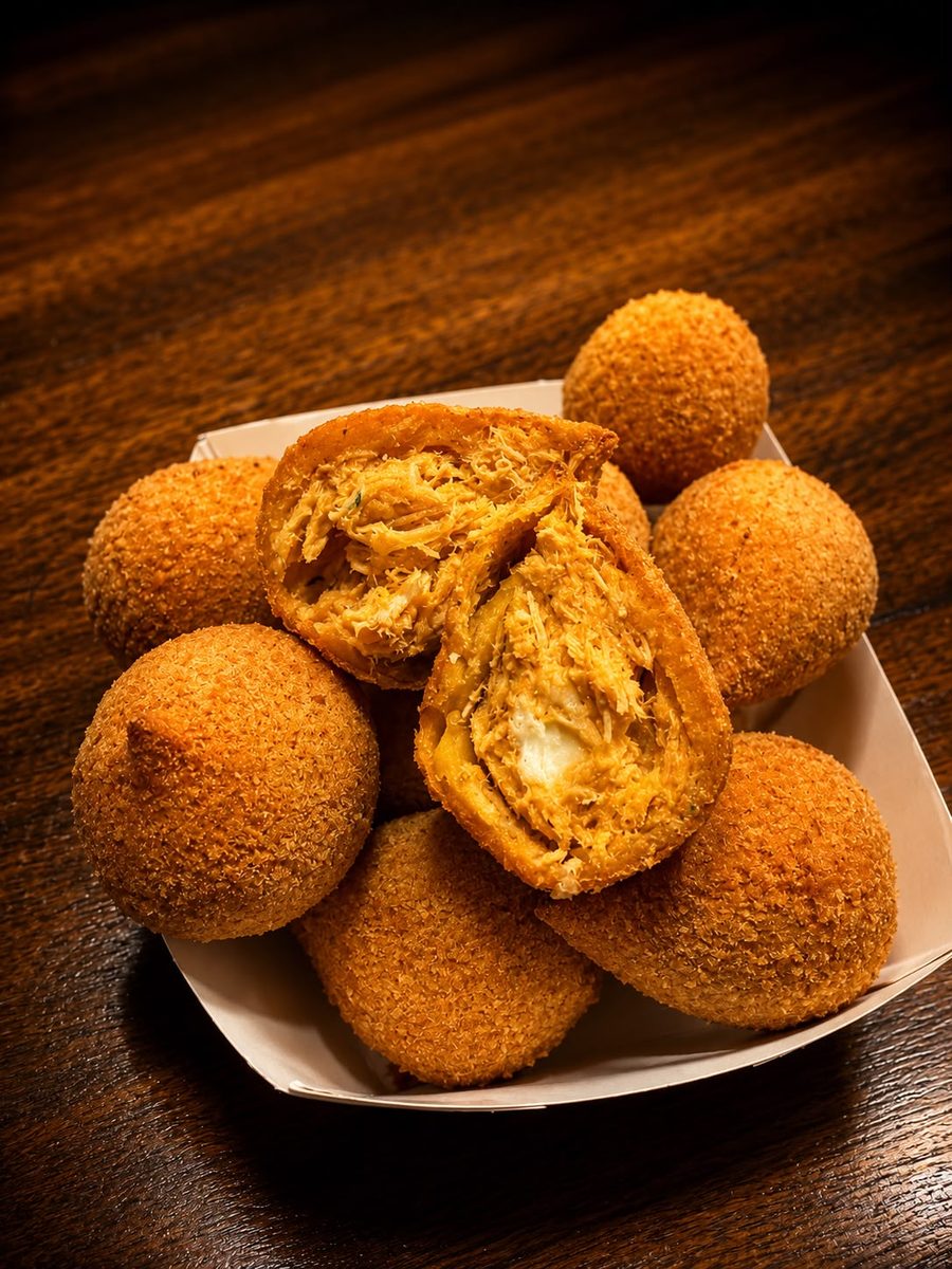 Golden coxinhas filled with shredded chicken